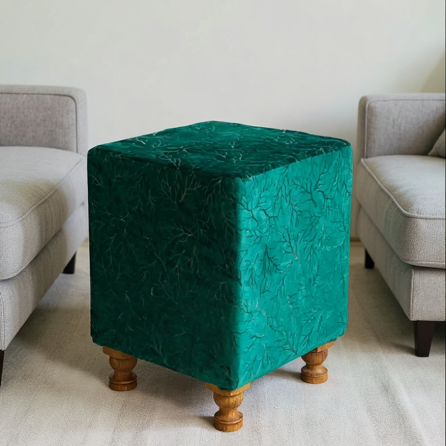 Teal cube-shaped ottoman with wooden legs in a living room setting
