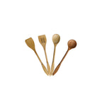 Set of four wooden kitchen utensils on a white background