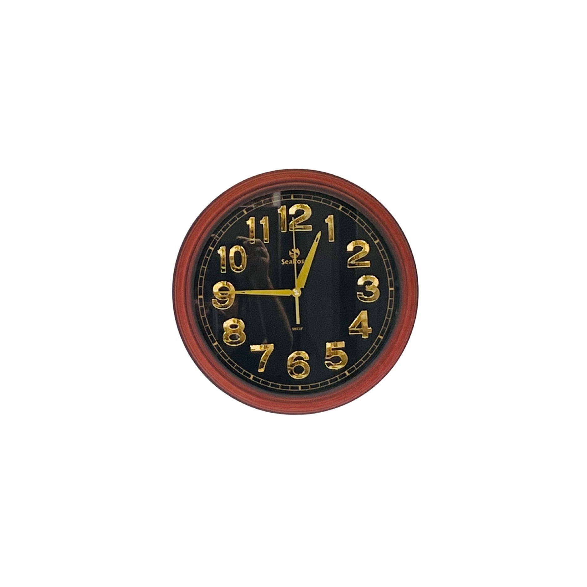 Round wall clock with black face and red frame on a white background