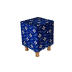 Cube-shaped ottoman with blue cover featuring a pattern on a white background