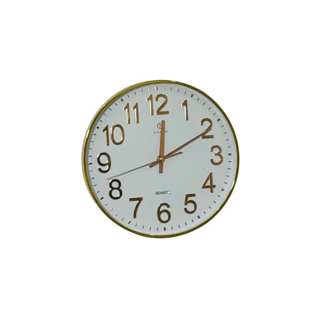 Round wall clock with gold frame and white face on a white background