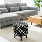 Gray sectional sofa with a patterned ottoman in a living room setting.