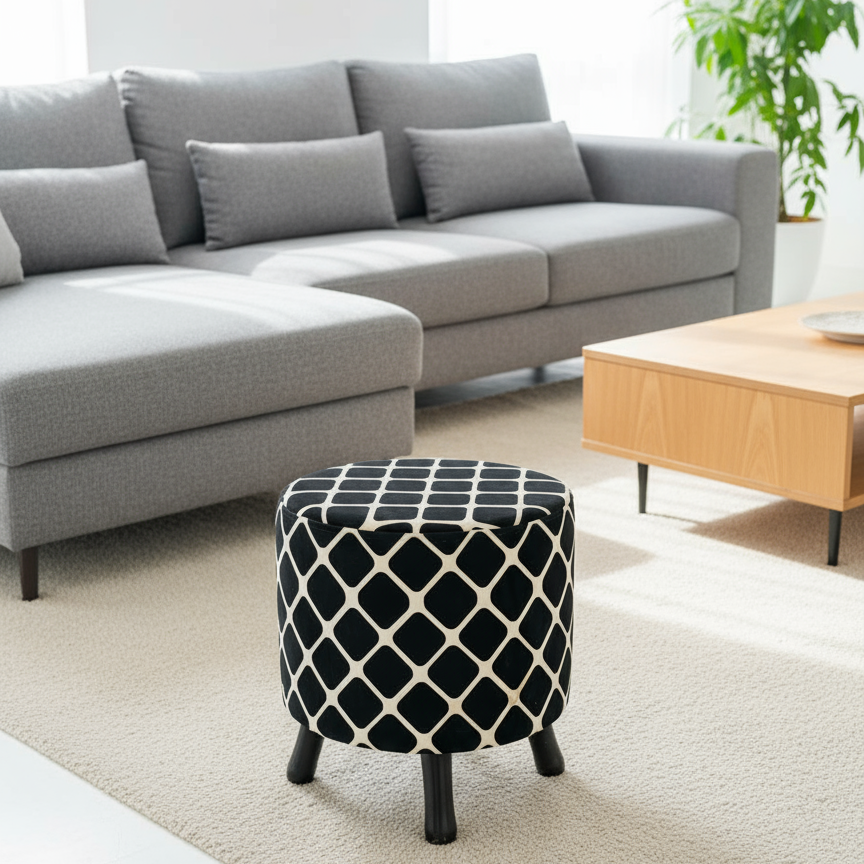 Gray sectional sofa with a patterned ottoman in a living room setting.