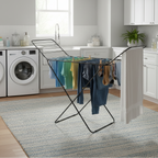 Laundry room with clothes on a drying rack and washing machines.