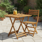 Wooden outdoor table with a chair and a pitcher of lemonade on a patio.