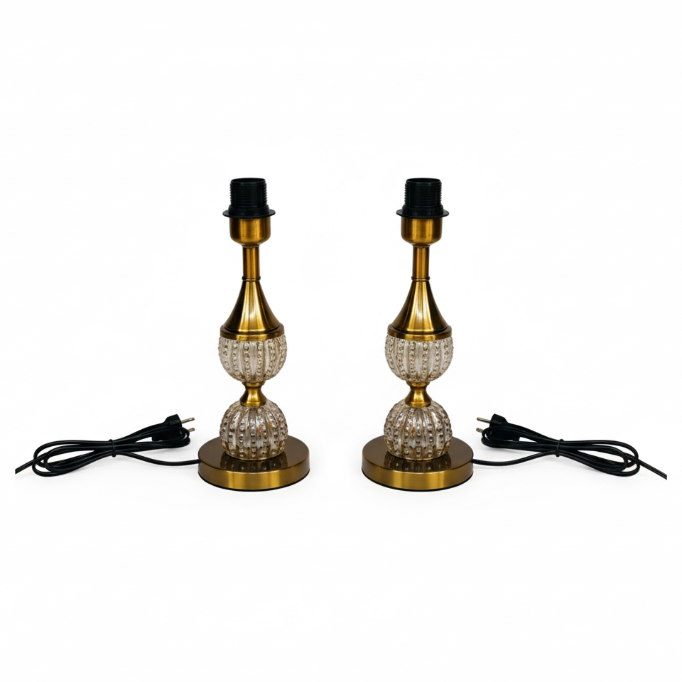 Two vintage-style table lamps with brass bases and clear glass shades on a white background.