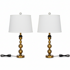 Two table lamps with brass bases and white shades on a white background