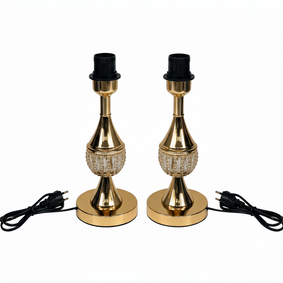 Two gold table lamps with black lampshades on a white background