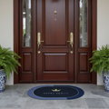 Wooden front door with gold handles, two potted ferns, and a doormat on a stone patio.