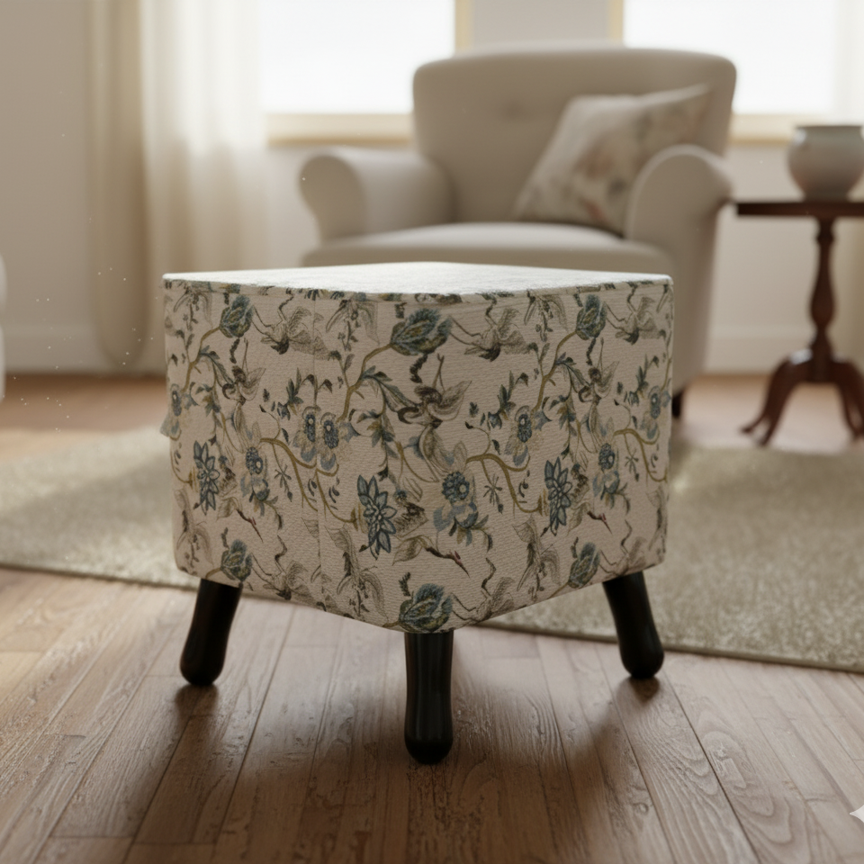 Floral-patterned ottoman in a living room setting with a blurred background