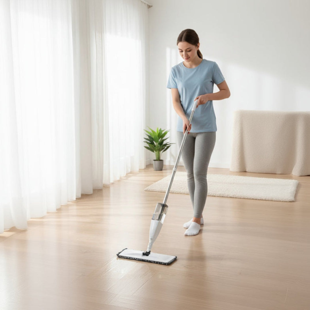 Woman cleaning a wooden floor with a mop in a bright room.