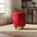 Red ottoman in a room with a desk and plants