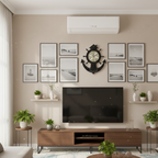 Modern living room with a television, decorative wall clock, and framed pictures.