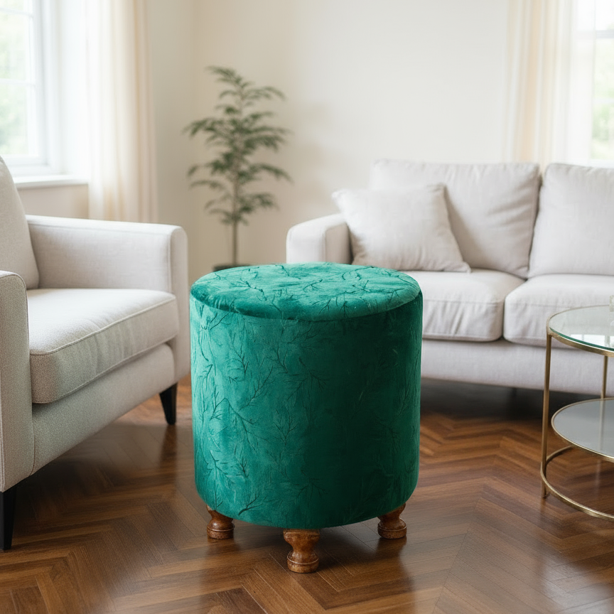 Green ottoman in a living room with white sofas and a wooden floor.